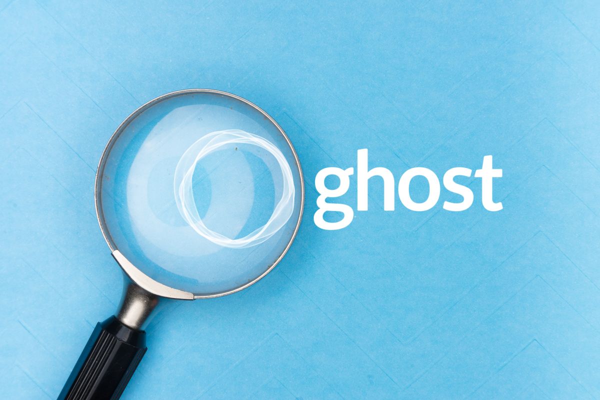 Magnifying glass with the Ghost logo against a blue background